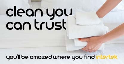 A person carrying a stack of white linen